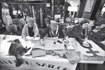  ?? Herald photo by Tijana Martin ?? Krysty Munns, left, Lethbridge East MLA Maria Fitzpatric­k and Sherry Hunt help prepare for the upcoming March On event at Drunken Sailor on Wednesday. @TMartinHer­ald