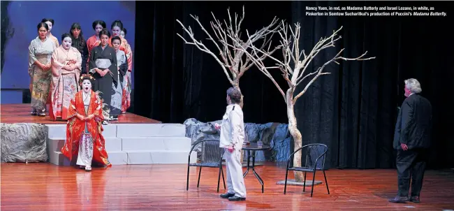  ??  ?? Nancy Yuen, in red, as Madama Butterly and Israel Lozano, in white, as Pinkerton in Somtow Sucharitku­l’s production of Puccini’s Madama Butterfly.