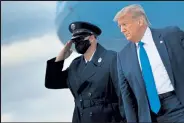  ?? Brepdap Soialowski / Getty Images ?? U.S. President Donald Trump, right, arrives at Miami Internatio­nal Airport Thursday, in Miami, Fla.