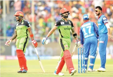  ??  ?? Virat Kohli(C) walks back to the pavilion after being dismissed for 41. - AFP photo