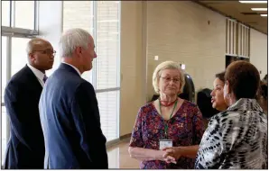  ?? Arkansas Democrat-Gazette/DALE ELLIS ?? Gov. Asa Hutchinson (front), attending the Rural Rise Summit on Wednesday in Pine Bluff, visits with (from left) Ryan Whatley, Go Forward Pine Bluff director; Mary Pringos, a Go Forward Pine Bluff member; Mildred Franco, director of The Generator, an innovation hub; and Pine Bluff Mayor Shirley Washington.