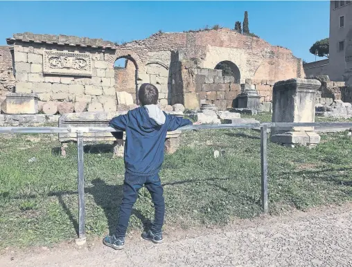  ?? Photos by Will Hawkes, for The Washington Post ?? Above: Fraser, 7, savors a trip to the Roman Forum. Top: Fraser at Pizzeria Galilei, with one of the many salami pizzas he consumed on the trip.