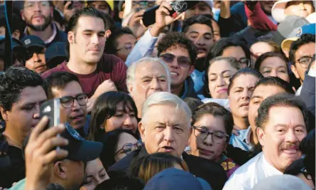  ?? FERNANDO LLANO/AP 2022 ?? President Andrés Manuel Lopez Obrador, center foreground, walks with backers at a pro-government march in Mexico City.