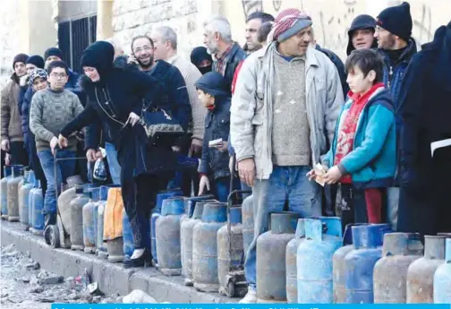  ??  ?? Syrians queue for gas canisters in the Salah al-Din district of the northern city of Aleppo on Feb 11, 2019. — AFP