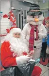  ??  ?? Santa and a friendly snowman brought festive cheer to the Claggan branch of SPAR.