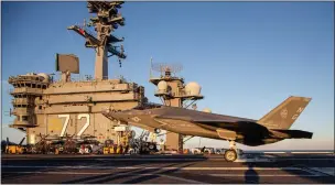  ?? FIRST LT. CHARLES ALLEN — MARINE CORPS ?? An F-35C Lightning
II, assigned to Marine Fighter Attack Squadron (VMFA) 314, arrives aboard the Abraham Lincoln to deploy alongside the Navy.