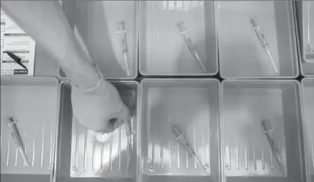  ?? Images Ian Forsyth/Getty ?? A member of the medical staff at the NHS Nightingal­e North East hospital lays out syringes of the AstraZenec­a/Oxford University Covid-19 vaccine on Jan. 26 in Sunderland, England.