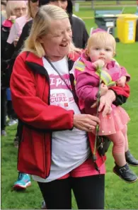  ?? PHOTOS BY RON SEYMOUR /The Daily Courier ?? Scenes from Sunday’s CIBC Run for the Cure in City Park, an annual fundraiser in support of breast cancer research. Cool and drizzly weather kept the turnout slightly below that seen in previous years.