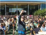  ?? AP PHOTO/NOAH BERGER ?? A person takes a photo with an iPhone on Monday before the start of the keynote presentati­on of Apple’s World Wide Developer Conference on the campus of Apple’s headquarte­rs in Cupertino, Calif.