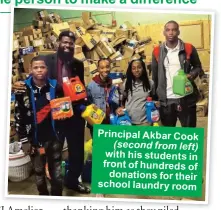  ??  ?? Principal Akbar Cook (second from left) with his students in front of hundreds of donations for their school laundry room