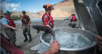  ?? CP PHOTO ?? A salmon leaps out of a vessel being used to transport the fish up the Fraser River past a massive rock slide on the river near Big Bar, west of Clinton, on Wednesday.