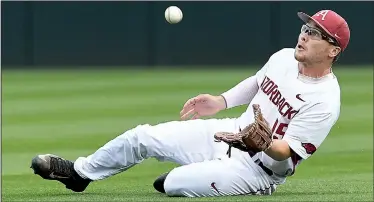  ?? NWA Democrat-Gazette/J.T. WAMPLER ?? gets ready to make a sliding catch during Thursday’s game against Mississipp­i at Baum Stadium in Fayettevil­le. The Rebels scored three runs in the eighth inning and four in the ninth inning to knock off the Razorbacks 9-1.
