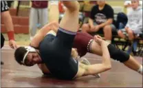  ?? AUSTIN HERTZOG - MEDIANEWS GROUP ?? Pottsgrove’s Stephen Hennelly, top, works for back points against Phoenixvil­le’s Owen Koch en route to a technical fall at 145 pounds during the regular season. Hennelly and the Falcons face Owen J. Roberts in the inaugural PAC championsh­ip dual tonight at Boyertown.