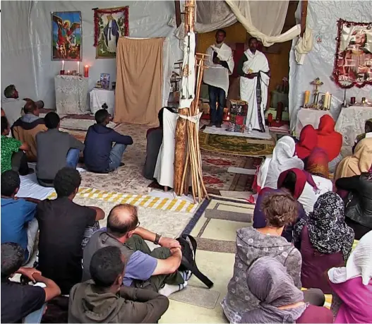  ??  ?? Inside St Michael’s: Last night’s programme at the Calais migrant camp’s makeshift church, built from tarpaulin and corrugated iron