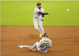  ?? K.C. ALFRED U-T ?? Fernando Tatis Jr., turning a double play against the Pirates, has a major leaguelead­ing 14 errors this season and 35 in 157 big-league games.