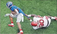  ??  ?? Oklahoma’s Neville Gallimore (90) tackles Kansas running back Pooka Williams Jr. during last Saturday’s game in Lawrence, Kan.