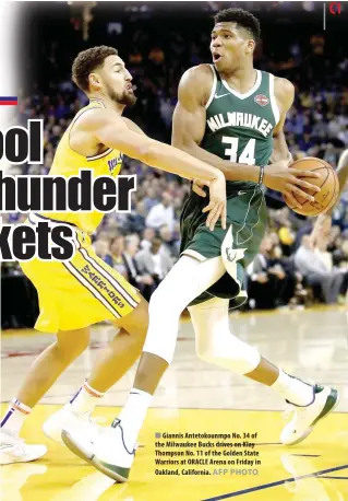  ?? AFP PHOTO ?? Giannis Antetokoun­mpo No. 34 of the Milwaukee Bucks drives on Klay Thompson No. 11 of the Golden State Warriors at ORACLE Arena on Friday in Oakland, California.