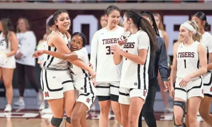  ?? STEVE SISNEY/FOR THE OKLAHOMAN ?? Norman players celebrate after beating Edmond Memorial in a Class 6A girls basketball state semifinal on Friday in Norman.