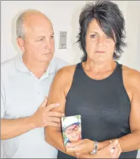  ?? CAPE BRETON POST PHOTO ?? Sherry Cable stood trembling with emotion and clutching a picture of her murdered son, Brandon Kelly, Monday after a Supreme Court hearing, alongside an unidentifi­ed man. Cable is not in support of a plea deal reached with offender Brandon James...