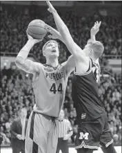  ?? Michael Conroy Associated Press ?? PURDUE’S Isaac Haas, who scored 24 points, shoots over Michigan’s Moritz Wagner in the second half.