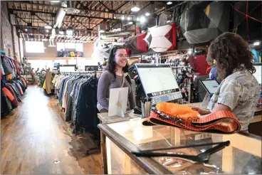  ?? PHOTOS: AARON ONTIVEROZ — THE DENVER POST ?? Louisa Kelly purchases used ski touring gear as Isabel Gourley rings her up at Feral mountain gear this week. Many independen­t outdoor retailers saw sales declines in 2023, but Feral is thriving thanks to buying and selling used gear.