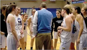 ?? Photo courtesy of JBU Sports Informatio­n ?? John Brown women’s basketball players listen as head coach Jeff Soderquist gives instructio­ns during last Saturday’s game against Ecclesia.