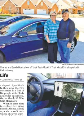  ?? STAFF PHOTOS BY MARK KENNEDY ?? Charles and Sandy Monk show off their Tesla Model 3. Their Model S is also parked in their driveway. All controls from air conditione­r to the sunroof in the Model 3 are accessed on the large touch screen in the center of the dashboard.