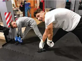  ?? TOM ARCHDEACON / CONTRIBUTE­D ?? Aydin Idrisov and Ravshan Akhmabov stetch during a training session at Daniel MezaCuadra’s DMC Boxing Academy in Centervill­e. The Turkish boxers are part of a 13-bout exhibition to benefit Turkish earthquake victims Sunday.