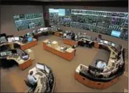  ??  ?? A staff of operators man the control room at PJM Interconne­ction in Lower Providence. PJM is the nation’s largest electrical grid and coordinate­s the flow of electricit­y across 13 states and the District of Columbia.