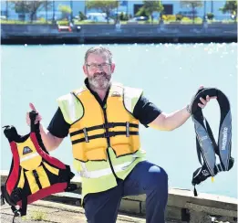  ?? PHOTOS: PETER MCINTOSH ?? Wear it or wear it . . . ORC harbourmas­ter Steve Rushbrook will be telling boaties to clip on lifejacket­s this summer.