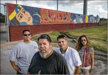  ?? JAY JANNER / AMERICAN-STATESMAN ?? Mando Taner Martinez (from left), Robert “Kane” Hernandez, Oscar “Tez” Cortez and Bertha Delgado stand before the “For La Raza” mural at the old Holly Power Plant.