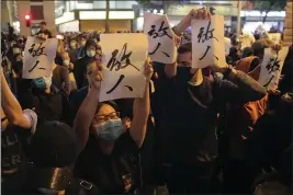  ?? KIN CHEUNG — THE ASSOCIATED PRESS ?? Protesters hold placards baring the words “Release People”, shout slogan as they gather near the Polytechni­c University in Hong Kong on Monday.