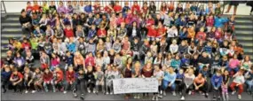  ?? SUBMITTED PHOTO ?? Starkweath­er Elementary School students present their donation to Unite for HER Founder Sue Weldon.