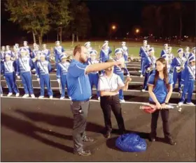  ?? JONATHAN TRESSLER — THE NEWS-HERALD ?? Band director Brett Tomko, assistant band director Kitty Stout and majorette adviser Stephanie Poling discuss some final preparatio­ns before the 130-member Madison High School Blue Streak Marching band does its thing at the Lake County Musical...