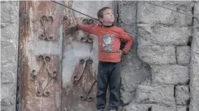  ?? ?? A Palestinia­n boy looks at a drone in the sky in the southern Gaza Strip city of Rafah on Tuesday, amid the ongoing conflict. — AFP