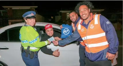  ?? Photo / Chris Loufte ?? Police officer Gabrielle Griffiths hands out free tickets to the Warriors’ next home game to motorist Kuki Ionatana, with Warriors Sam Lisone and Agnatius Paasi (right).