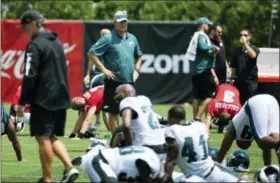  ?? CHRIS SZAGOLA — THE ASSOCIATED PRESS ?? Philadelph­ia Eagles head coach Doug Pederson looks over his team at NFL football training camp Thursday in Philadelph­ia.