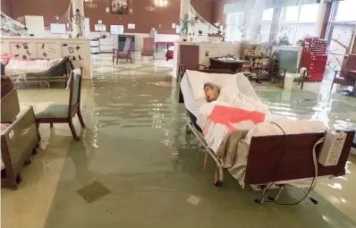  ??  ?? Surrounded by water: An elderly patient at Gulf Health Care Centre in Port Arthur, Texas
