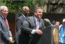  ?? JOHN BERRY — THE TRENTONIAN ?? New Jersey Gov. Chris Christie answers questions during a press conference Tuesday at Trenton’s Mill Hill Park. Behind him are NJ Department of Community Affairs Commission­er Charles Richman and Trenton Mayor Eric Jackson.