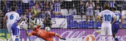  ??  ?? LA CORUNA: Real Madrid’s Costa Rican goalkeeper Keylor Navas stops a penalty shot by Deportivo La Coruna’s Romanian forward Florin Andone (R) during the Spanish league footbal match RC Deportivo de la Coruna vs Real Madrid CF at the Municipal de Riazor stadium in La Coruna on Sunday. — AFP