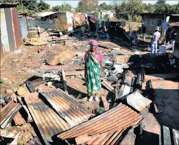  ?? PICTURE: ITUMELENG ENGLISH ?? ASHES: Martha Baloyi, the grandmothe­r of a 3-year-old boy who was burnt when the shack he was sleeping in was set alight during an altercatio­n on Monday night in Kliptown, Soweto.