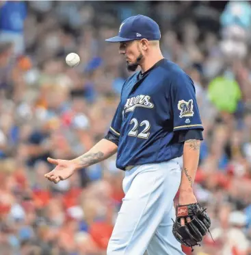  ?? BENNY SIEU / USA TODAY SPORTS ?? Brewers pitcher Matt Garza tosses the ball during a pitching change in the sixth inning on Thursday against the Cardinals at Miller Park. Garza gave up four hits and one run but struck out four and helped lead the Brewers to a 2-1 victory.