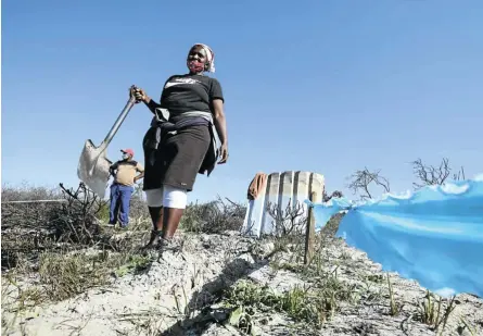  ?? Picture: Esa Alexander . ?? Sakhiwo Krweca, left, and Nokwananda Mankayi used sticks, pieces of plastic and string to demarcate plots for themselves in Cape Town’s Driftsands Nature Reserve during winter’s hard lockdown last year, when flooding drove them from their homes in a neighbouri­ng settlement.