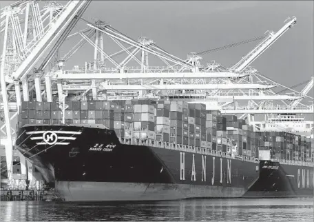  ?? Bob Chamberlin Los Angeles Times ?? CONTAINER SHIPS are loaded at the Port of Long Beach in 2015. Globalizat­ion has turned into a symbol of job loss and wage stagnation.