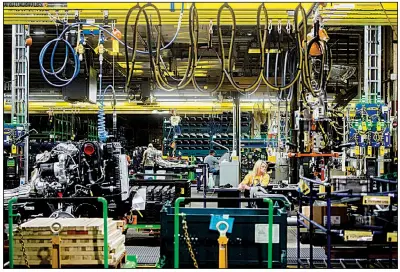  ?? AP ?? General Motors employees work on the chassis line in June at GM’s assembly plant in Flint, Mich. A key U.S. factory gauge unexpected­ly contracted in August for the first time in three years as slowing growth was reported by seven manufactur­ing industries, including transporta­tion.