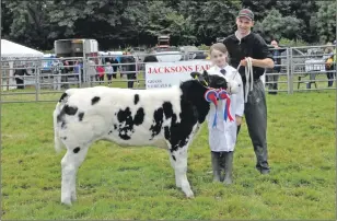  ??  ?? John Morris of Knockleara­ch with the cattle champion, a British Blue cross, and his daughter Lauren, nine, who won best young handler in the cattle section. 16_T33_ Islay Show_ 04