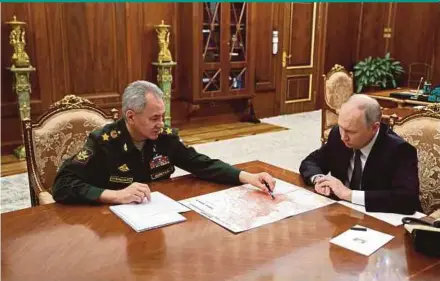  ?? AFP PIC / SPUTNIK ?? Russian President Vladimir Putin having a meeting with Defence Minister Sergei Shoigu at the Kremlin in Moscow on Tuesday.