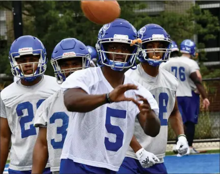  ?? PAUL DICICCO — FOR THE NEWS-HERALD ?? South graduate D.J. Greene looks in a pass during Notre Dame College’s first practice on Aug. 12.