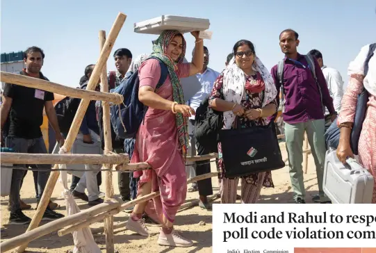  ?? — REUTERS ?? Polling officers make their way as they carry election materials at a distributi­on centre ahead of the second phase of the general elections, in Barmer in the desert state of Rajasthan on Thursday.