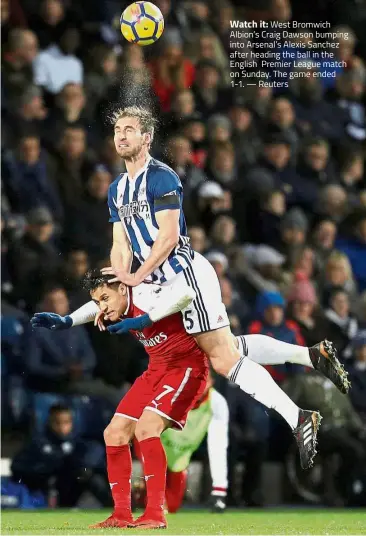  ?? — Reuters ?? Watch it: West Bromwich Albion’s Craig Dawson bumping into Arsenal’s Alexis Sanchez after heading the ball in the English Premier League match on Sunday. The game ended 1-1.